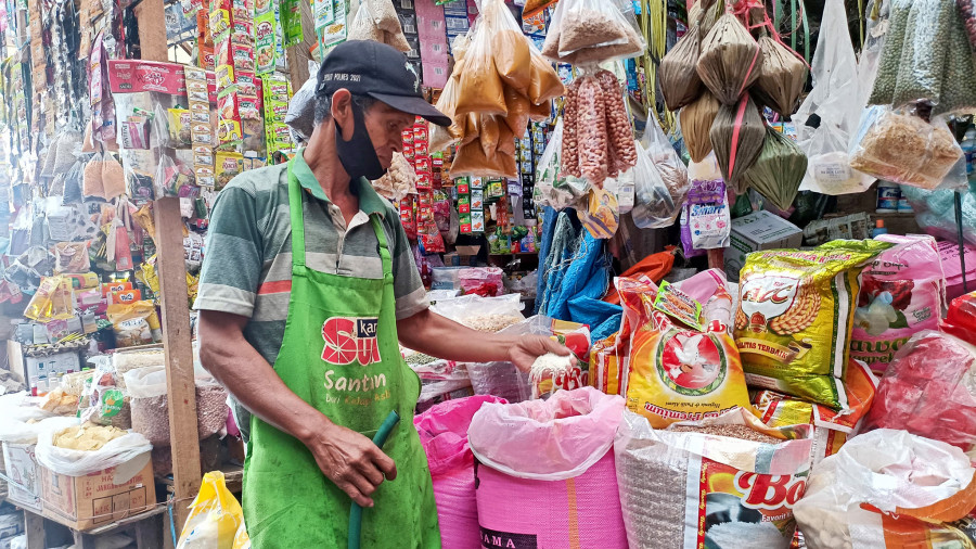 Seorang pedagang menunjukkan bahan pokok di Pasar Induk Nenang, Kecamatan Penajam, Kabupaten Penajam Paser Utara. (Foto: Dinda/Korankaltim.com)
