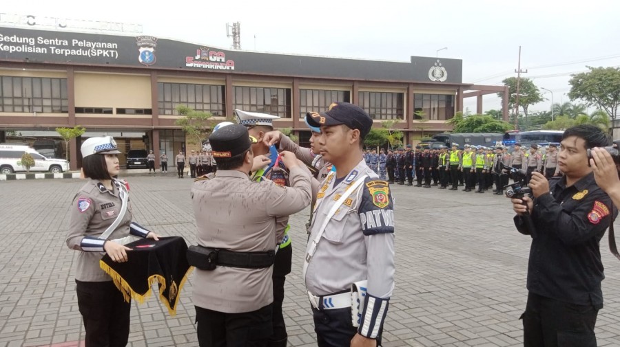 Wakapolresta Samarinda AKBP Heri Rusyaman saat menyematkan pita ke personil sebagai tanda di mulai nya Operasi lilin Mahakam 2025 (Istimewa)